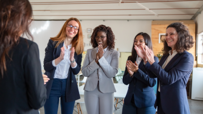 A group of happy employees clapping