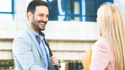 Two people smiling and shaking hands