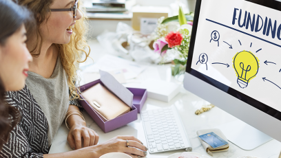 Two women searching funding on the computer