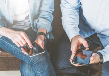 Two people on their phones