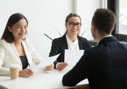 Two recruiters interviewing a man for a job