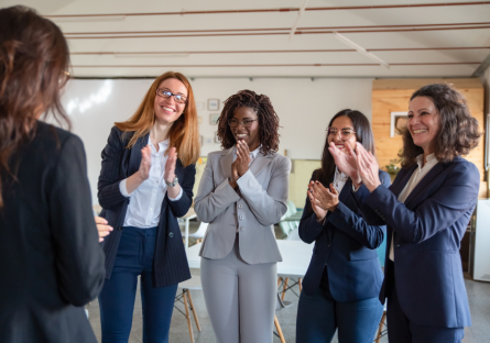 A group of happy employees clapping