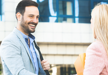 Two people smiling and shaking hands