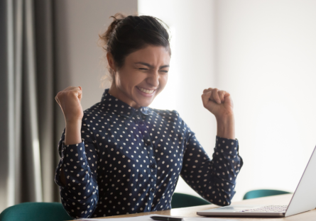 An employee celebrating reaching her professional goals