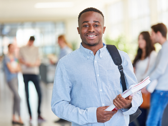 Male college student holding a book