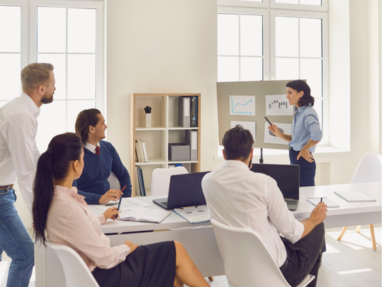 Woman teaching colleagues at work