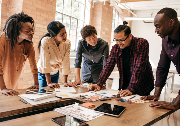 Group of people standing up in a meeting