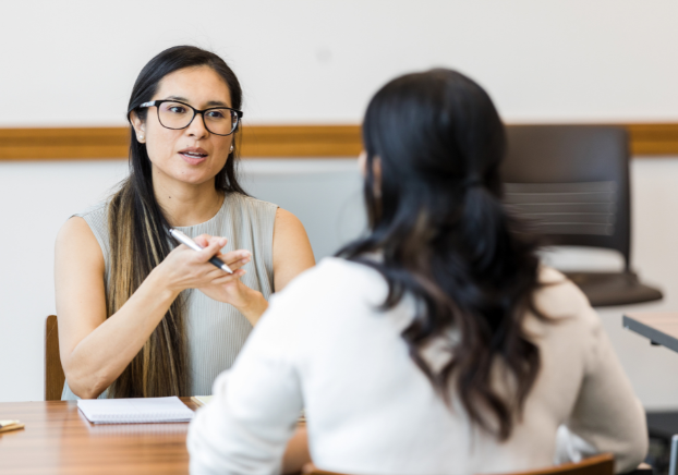 Two female professionals resolving a conflict