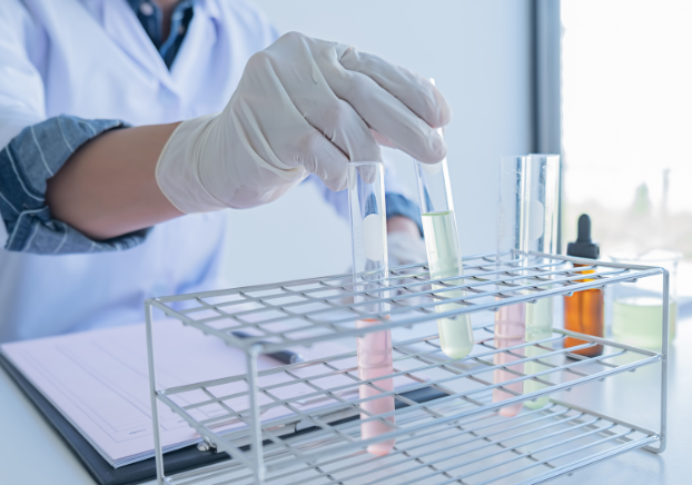 Chemist putting vials in a placeholder