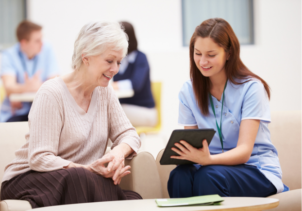 Medical professional talking with patient while viewing chart