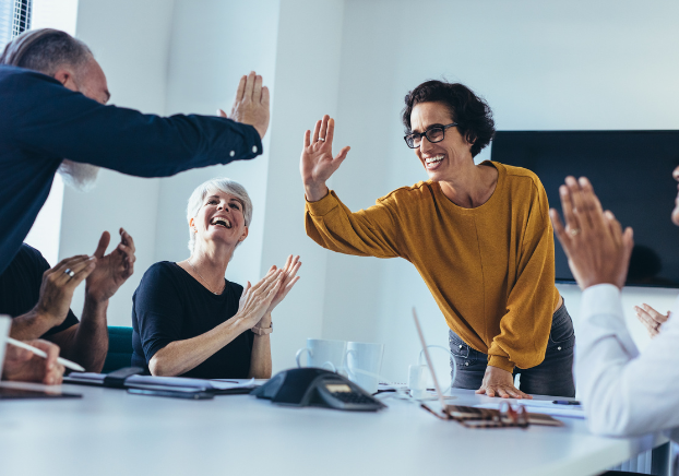 Woman high-fiving a colleague at work