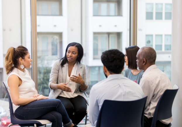 Group of professionals sitting in a circle discussing business