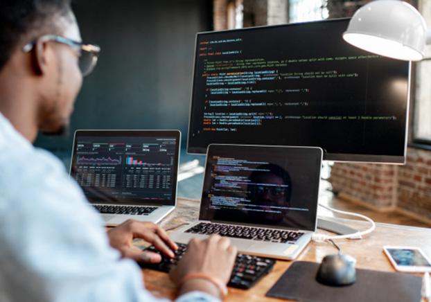 Man working on coding on computer