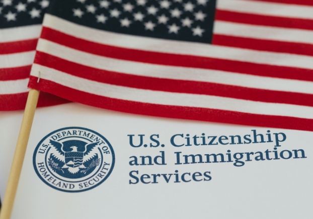American flag with the U.S. Citizenship and Immigration Services logo